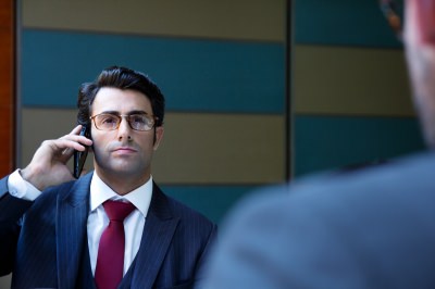 man using phone during interview